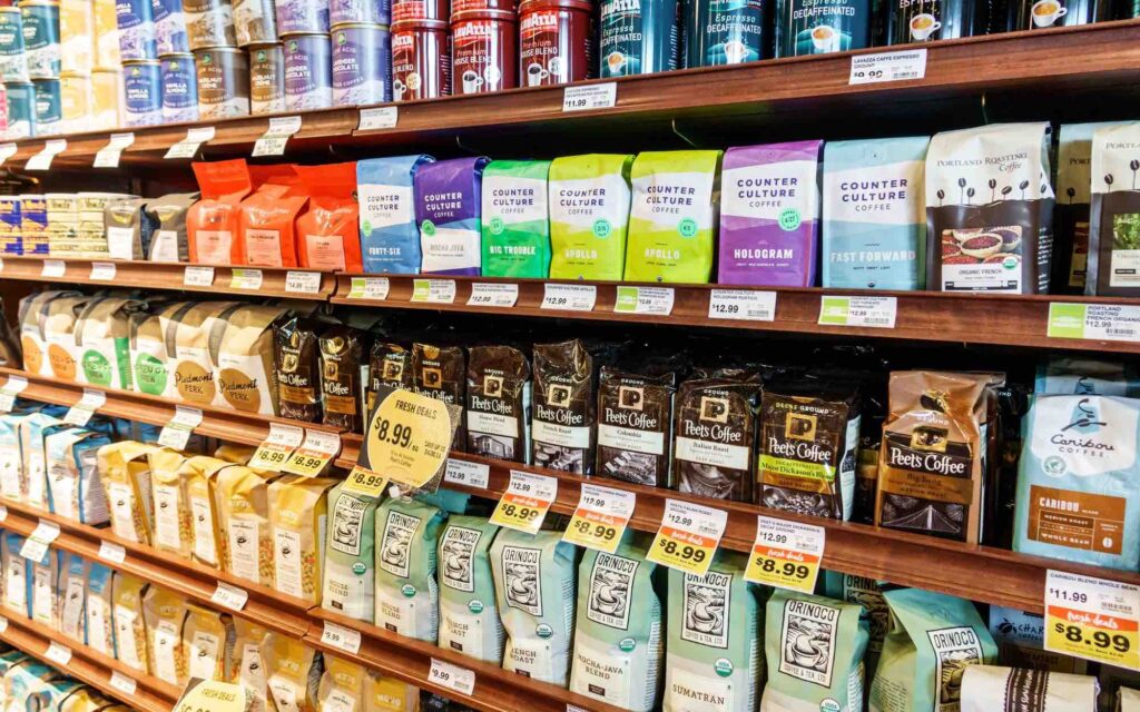 Coffee bags on grocery store shelves.