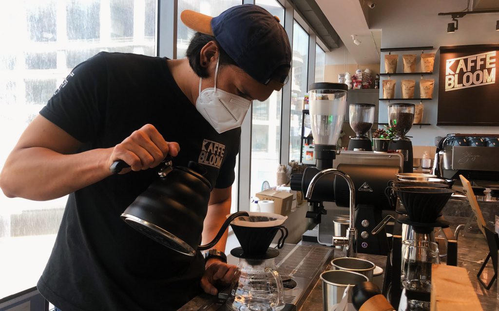 A barista prepares a V60 at Kaffebloom in the Middle East.